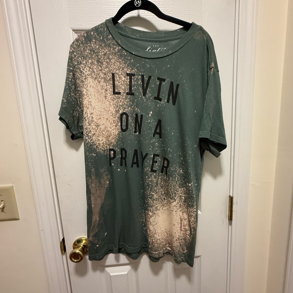 The Light Blonde Bleached Living on a Prayer Green Graphic T-Shirt with Text